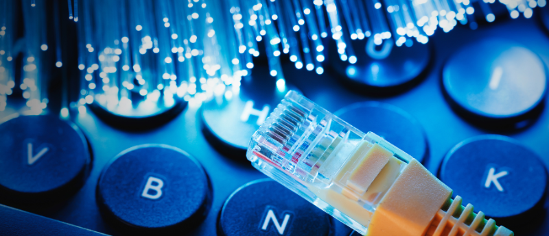 Fiber optic cables glowing in different colors, symbolizing high-speed internet data transmission