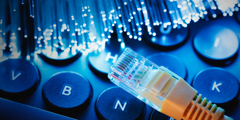 Fiber optic cables glowing in different colors, symbolizing high-speed internet data transmission