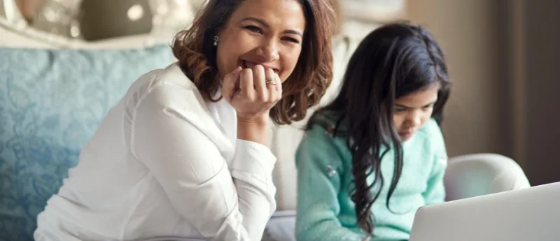 A parent enabling parental control features on a laptop for safe internet use.