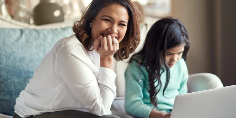 A parent enabling parental control features on a laptop for safe internet use.