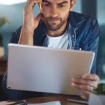 Person overwhelmed by screen time reflecting signs of internet addiction