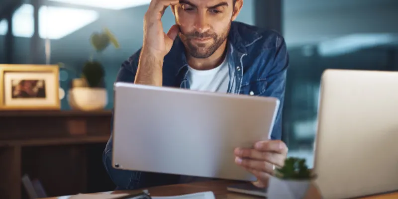 Person overwhelmed by screen time reflecting signs of internet addiction